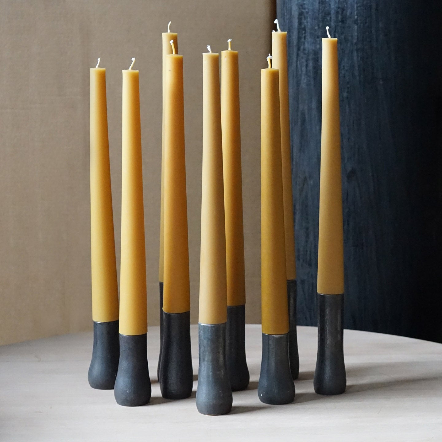 9 Grove candles placed together atop of a table