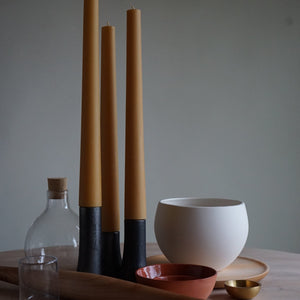 various items on a table including: 3 grove candle sticks and holders, a round white grow pot, a glass pitcher and a bowl