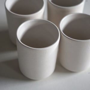 4 white 3" porcelain cups