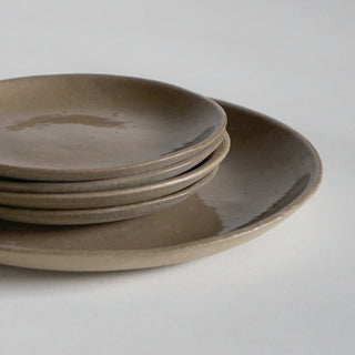 stack of 4 oatmeal stone 6.5" side plates sitting on a dinner plate