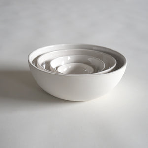 4 white porcelain bowls nested together